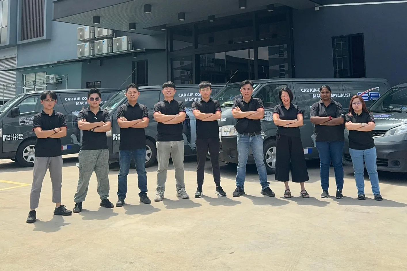 The SPZONE team outside the Speed Car Auto Parts headquarters with the company service fleet